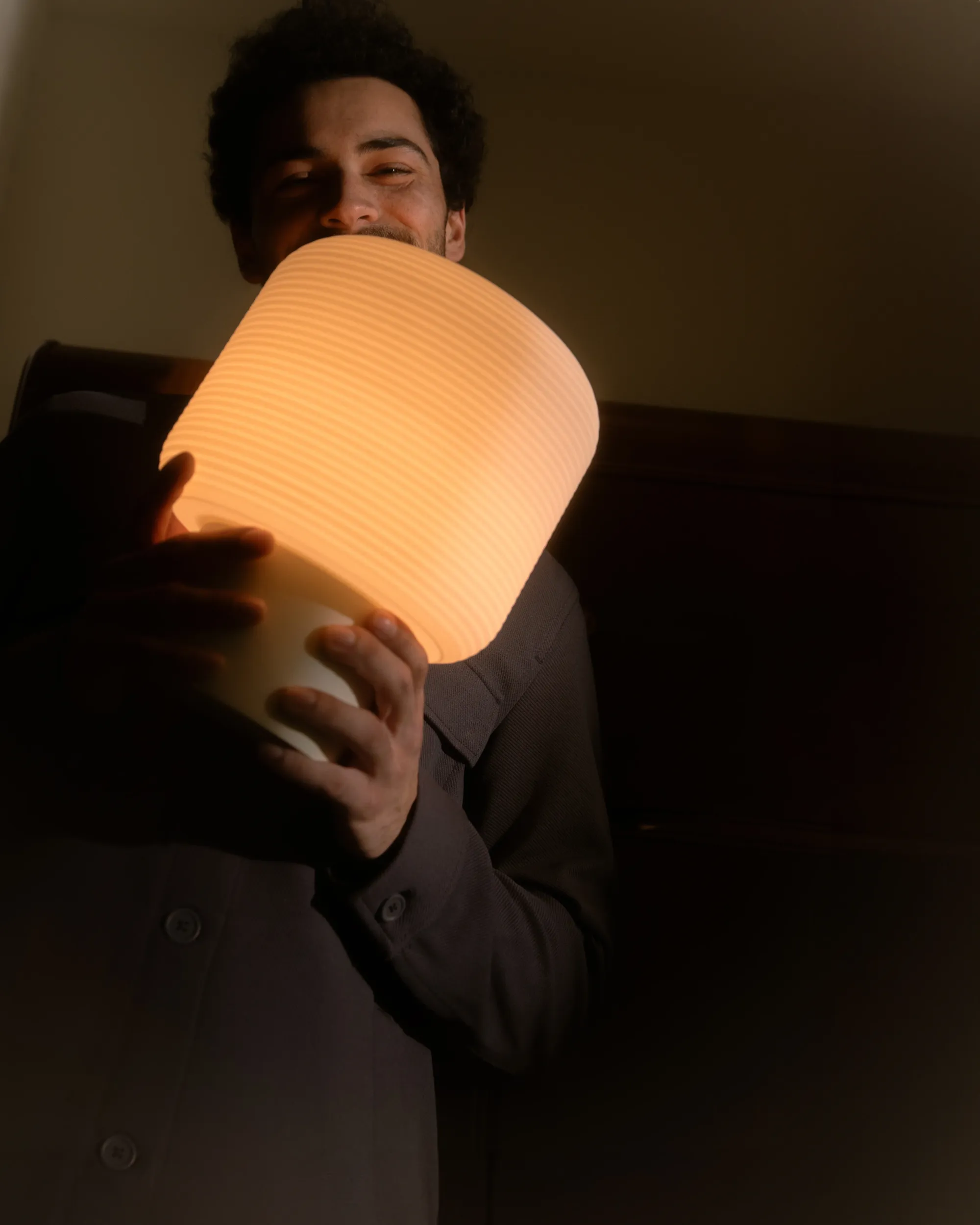 A man smiling while holding Gantri’s Maskor Table Light