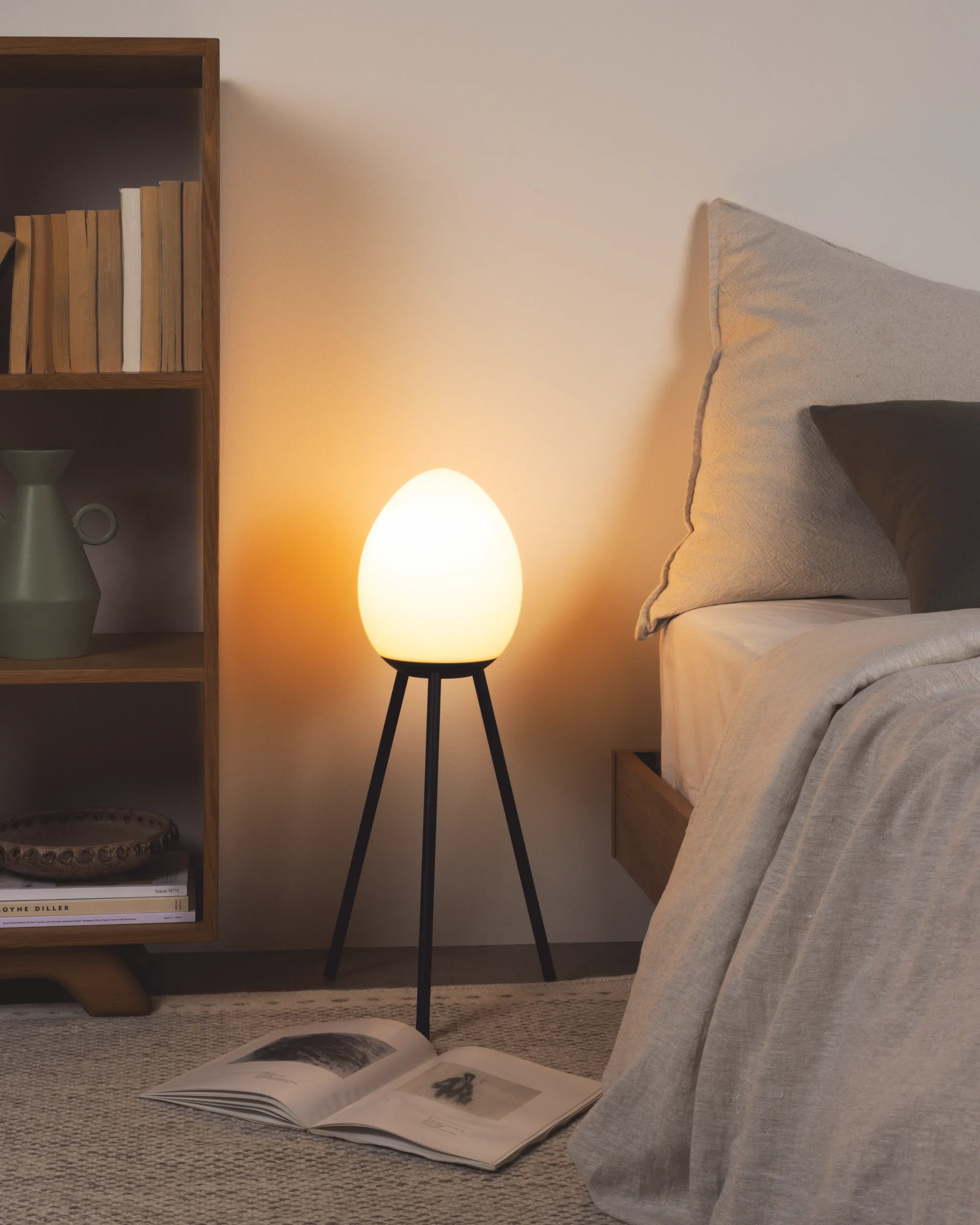 A bedroom nook is lighted up by a Gantri Baltra floor lamp