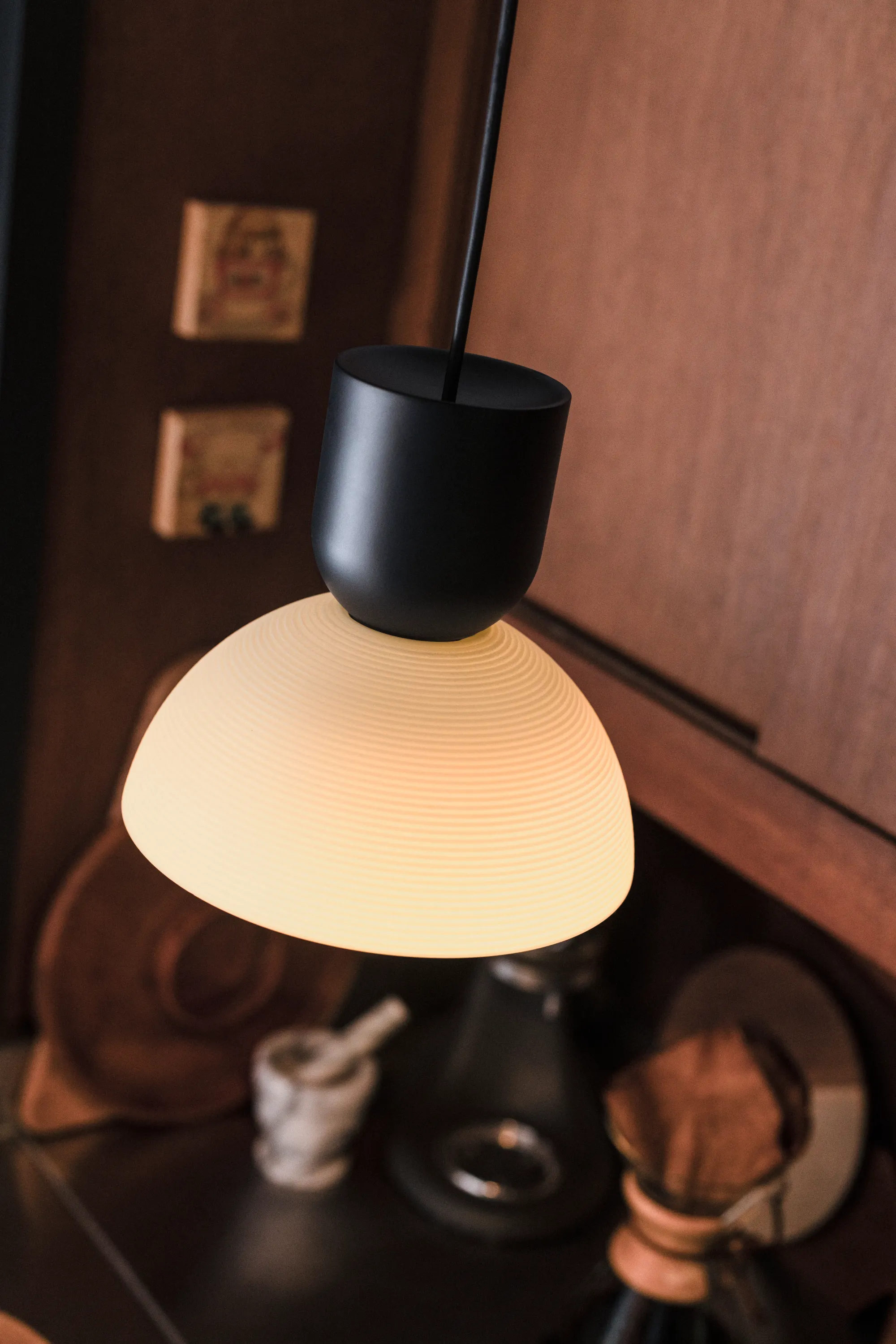 A Gantri Buia Pendant Light illuminated over a kitchen area 