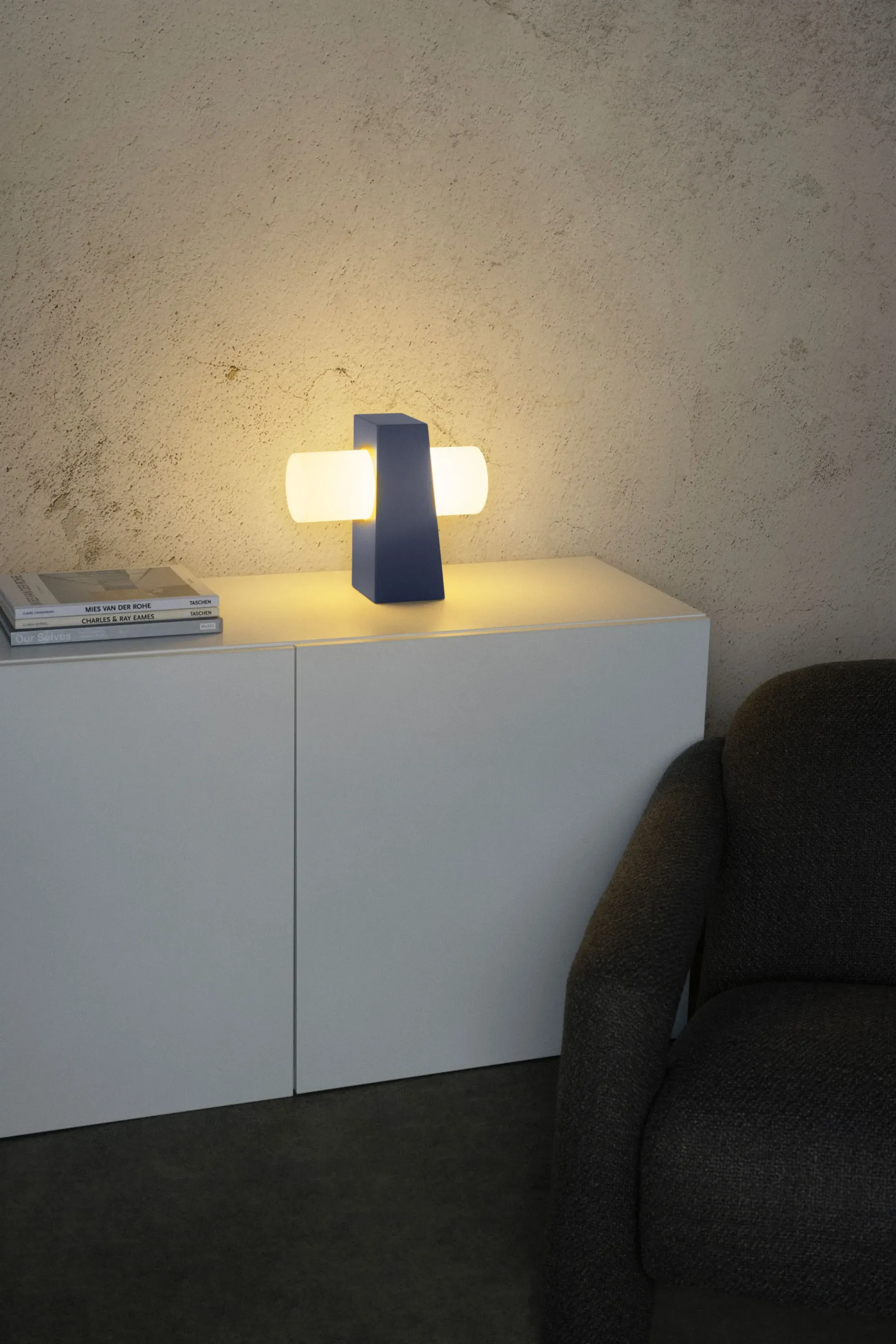 A Gantri Figra Table Lamp perched on a living room drawer