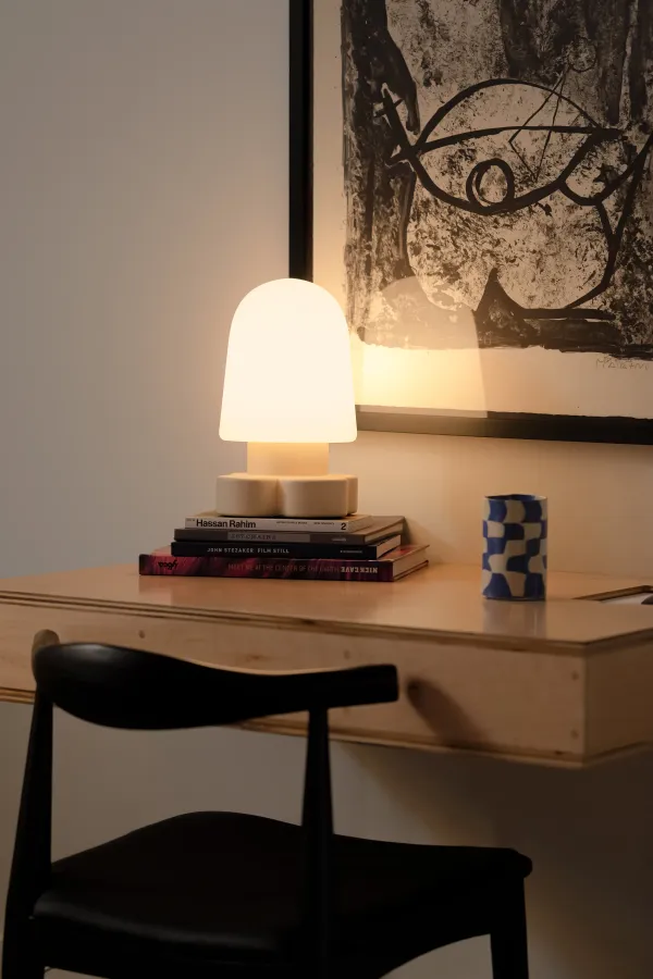 A multipurpose space with books and an illuminated Gantri Tiny Table light 