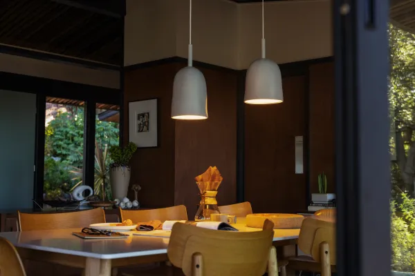 A kitchen table illuminated by a Gantri Vessel pendant light